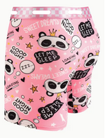 Pink boxer briefs with a playful cartoon panda print, featuring text like 'SWEET DREAMS', 'LET ME SLEEP', and 'GOOD NIGHT' along with stars and speech bubbles. The brand name 'CAOHUAEN' is visible on the waistband.
