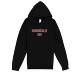 Black hoodie with “CHRONICALLY GAY” text displayed on white background, part of eco-friendly LGBTQ fashion drop